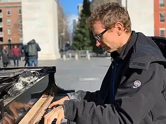 Huggins playing piano in Washington Square Park in January 2019