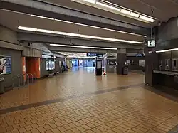 A wide pedestrian tunnel with several exits