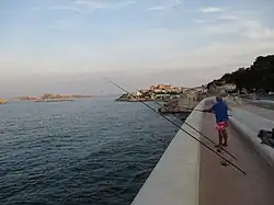Fishermen on the Corniche with the Frioul archipelago in the distance