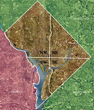 Color-enhanced USGS satellite image of Washington, D.C., taken April 26, 2002. The "crosshairs" in the image mark the quadrant divisions of Washington, with the U.S. Capitol at the center of the dividing lines. To the west of the Capitol extends the National Mall, visible as a thin green band in the image. The Northwest quadrant is the largest, located north of the Mall and west of North Capitol Street.