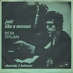 A single cover showing Dylan wearing sunglassses, sitting at an upright piano