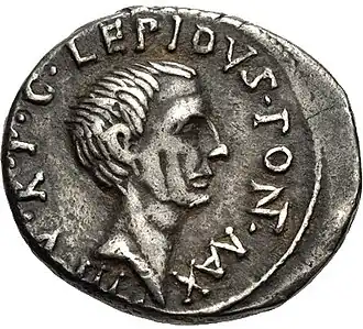 Grey coin depicting male head facing right