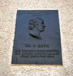 Memorial plaque for Dr. Desiderius Beck at the former hotel's northern wall
