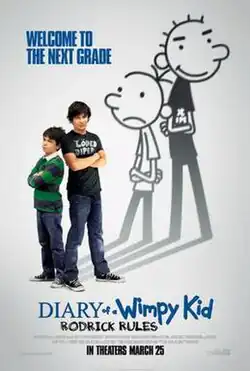 Greg and Rodrick Heffley stand beside each other, with their arms folded, in front of their shadows resembling their original illustrations.