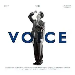 Man in the middle behind words of "Voice"
