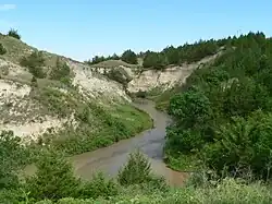 Small river running between steep banks