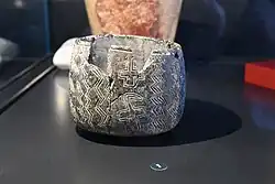 Stone vessel with undulating snake symbols