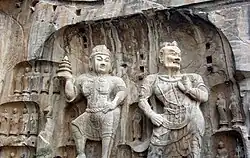 Large size Buddist statues carved in stone from a cliff wall