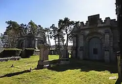 Mausoleum adjacent to the church (right) and second Mausoleum outside the churchyard (left)