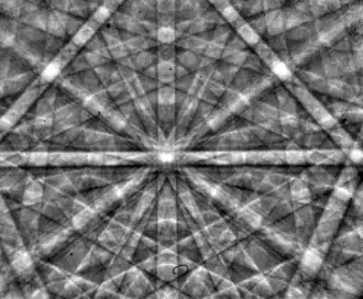 An electron backscatter diffraction pattern of monocrystalline silicon, taken at 20 kV with a field-emission electron source. The Kikuchi bands intersect at the centre of the image