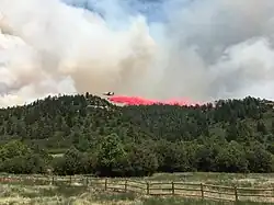 Airplane dropping fire retardant on June 18, 2020