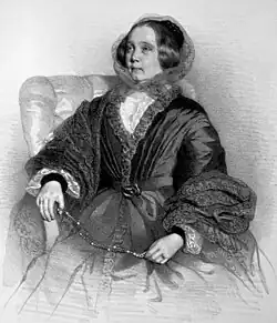 Sketch of a woman wearing an ornately lacy and pleated overcloak with flounced sleeves and a headscarf seated in an overstuffed armchair and holding a beaded necklace