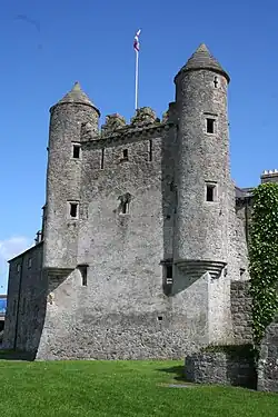 A color photograph of one side of a castle wall painted grey