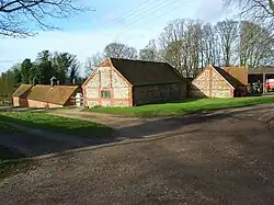 The combination of brick quoins with flint walls is common in (mostly older) buildings in this area of the Chilterns, Oxfordshire, England.