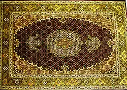 A Tabriz carpet with a fish design medallion