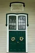 Front door with church history above