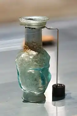 Glass vessel with a face, dated to the 1st or 2nd century CE