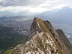 Rocky ridges dominating a settlement in the background.
