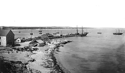 Tall ships off Fremantle Jetty with Bathers Beach in the foreground in 1870