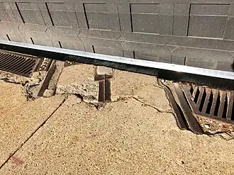 Streetcar tracks and conduit outside the garage's new east door (December 2018)