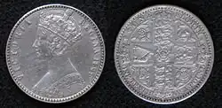 Both sides of a silver coin, with a crowned woman on one side and shields on the other
