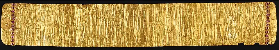 The Golden Letter. The mythical bird Hamsa is depicted on the left. Rows of rubies are set on both left and right. Damage from 1768 can be recognized at bottom-right.