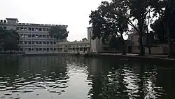 Large pond and college buildings