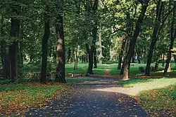 A paved walkway in the Great Cemetery park in Riga, Latvia
