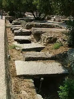 A trench, covered with stone slabs approximately a meter wide.