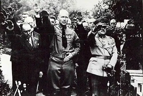 Decorated man (centre) with a toothbrush moustache