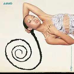 An image of Griff with her closed eyes lies on her side, her long braided hair arranged in a spiral pattern on the ground. She wears a sparkly, sequined top with delicate chains. The background is light-coloured, and the album title' is written along the right edge of the image.