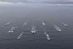 a group of warships at sea seen from high up
