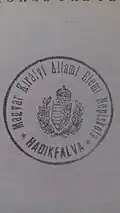 Hadikfalva public school stamp for a Hungarian-language school in Dornești, issued during Austro-Hungarian times, with the coat of arms of the Kingdom of Hungary depicted in the middle