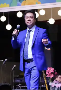 Alejandro performing in a well-decorated room