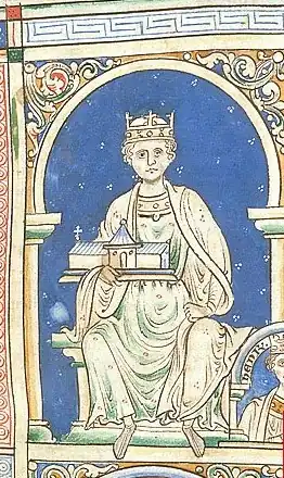 An image of King Henry II, portraying him in all white on a blue background. King Henry is sitting, holding a church. He has a royal crown on his head.