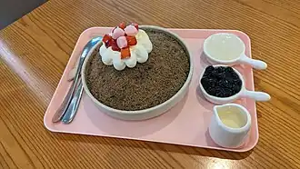Hojicha bingsu served with tapioca pearls, condensed milk and coconut.