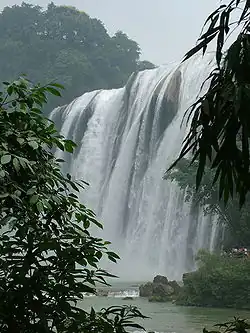 A large waterfall surrounded by lush vegetation
