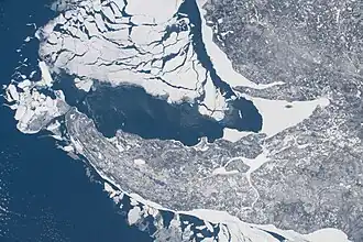 Some shelf ice remains along the shore of the peninsula as most of the ice breaks away; taken at 11:12:06 AM Central Standard Time on February 20, 2021 from the International Space Station