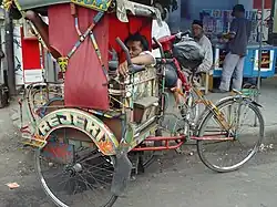 A becak and its driver wait for a fare in Bandung, Indonesia