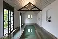 Indoor pool of the spa with open door leading to the garden.