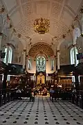 Inside St Clements Danes church; the black spots on the floor are the badges