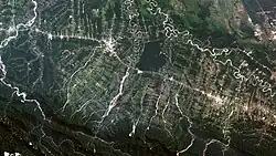 Image 1Satellite view of coca leaf and tropical fruit plantations in the Ivirgazama region of Bolivia. Several tropical areas in the country have experienced major deforestation. (from Economy of Bolivia)