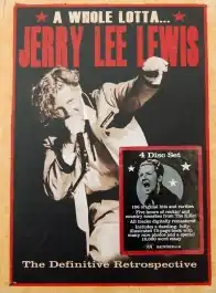 A blonde-haired man standing up holding a microphone