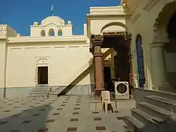 Entrance of shrine 14, Chandella period, 19th century gateway in background