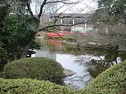 Traditional Japanese garden with pond, rocks, and mature trees
