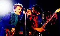 Three men performing at a concert