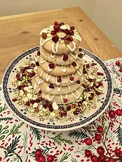 A small kransekake, decorated with nuts and fruit as well as the traditional white glaze