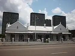 A Dutch colonial-style house with the flag of the South African Republic flying outside.