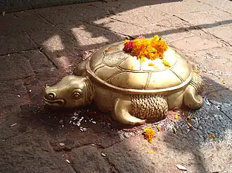 Brass sculpture of a tortoise.