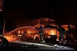 Burning buses in Kyiv after an attack, 16 May 2023